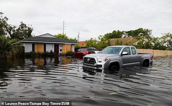 Mandatory Credit: Photo by Lauren Peace/Tampa Bay Times/ZUMA Press Wire/Shutterstock (14774453e) A vehicle in the flooded waters at 28th street at 15th Ave N on Thursday, Oct. 10, 2024, in St. Petersburg. Residents, who live in a nonevac and high elevation area, unexpectedly had water in their home after it spilled from a retention pond Wednesday night from Milton on Oct. 10, 2024, in St.Petersburg. Florida News, St. Petersburg, USA - 10 Oct 2024