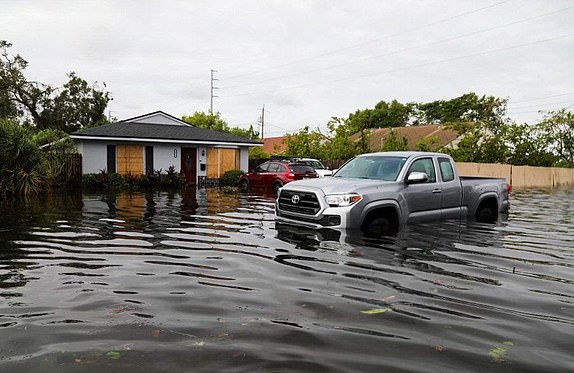 Mandatory Credit: Photo by Lauren Peace/Tampa Bay Times/ZUMA Press Wire/Shutterstock (14774453e) A vehicle in the flooded waters at 28th street at 15th Ave N on Thursday, Oct. 10, 2024, in St. Petersburg. Residents, who live in a nonevac and high elevation area, unexpectedly had water in their home after it spilled from a retention pond Wednesday night from Milton on Oct. 10, 2024, in St.Petersburg. Florida News, St. Petersburg, USA - 10 Oct 2024