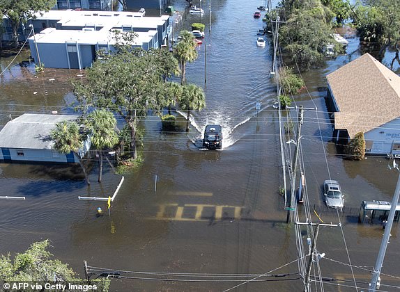 An aerial view shows a Sheriff's Department vehicle moving through flooded streets in Tampa, Florida, due to Hurricane Milton on October 10, 2024. Hurricane Milton tore a coast-to-coast path of destruction across the US state of Florida, whipping up a spate of deadly tornadoes that left at least four people dead, but avoiding the catastrophic devastation officials had feared. (Photo by Bryan R. SMITH / AFP) (Photo by BRYAN R. SMITH/AFP via Getty Images)