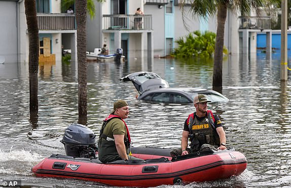 A water rescue boat moves in floodwaters at an apartment complex in the aftermath of hurricane Milton, Thursday, Oct. 10, 2024, in Clearwater, Fla. (AP Photo/Mike Stewart)